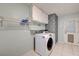 Functional laundry room with washer, dryer, upper cabinets, and practical shelving at 3917 Leon Ave, Las Vegas, NV 89130