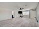 Spacious living room with light wood floors, ceiling fan, and minimalist decor at 3917 Leon Ave, Las Vegas, NV 89130