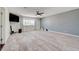 Open living room showcasing light wood floors, a ceiling fan, and access to the backyard at 3917 Leon Ave, Las Vegas, NV 89130