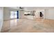 Open living space with sleek floors, ceiling fan, white walls, with seamless flow to the kitchen at 3917 Leon Ave, Las Vegas, NV 89130