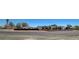 Wide street view of a neighborhood featuring single-story homes with well-kept yards and desert landscaping at 3917 Leon Ave, Las Vegas, NV 89130