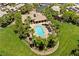 Aerial view of a community pool and clubhouse surrounded by lush greenery and well-manicured lawns at 4212 Helens Pouroff Ave, North Las Vegas, NV 89085
