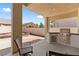 Outdoor patio featuring a built-in grill, ceiling fan, and ample seating area, ideal for barbecues and relaxation at 4212 Helens Pouroff Ave, North Las Vegas, NV 89085