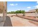 Spacious backyard with desert landscaping, including a covered patio for outdoor dining and lounging at 4212 Helens Pouroff Ave, North Las Vegas, NV 89085