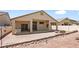 Home's backyard featuring a covered patio, hardscape, and a built-in outdoor grill, perfect for relaxing outside at 4212 Helens Pouroff Ave, North Las Vegas, NV 89085