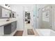 Modern bathroom with marble tiled walk-in shower, soaking tub, dual sink vanity, and contemporary finishes at 4212 Helens Pouroff Ave, North Las Vegas, NV 89085