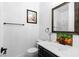Well-lit bathroom featuring vanity with sink, a framed mirror, and a glass-enclosed shower at 4212 Helens Pouroff Ave, North Las Vegas, NV 89085