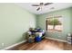 Comfortable bedroom offering hardwood floors, and a bright sunny window with serene tree view at 4212 Helens Pouroff Ave, North Las Vegas, NV 89085