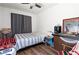 Cozy bedroom with hardwood floors, natural light, and a ceiling fan at 4212 Helens Pouroff Ave, North Las Vegas, NV 89085
