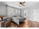 Comfortable bedroom features modern ceiling fan, and a cozy sitting chair for unwinding at 4212 Helens Pouroff Ave, North Las Vegas, NV 89085