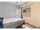 Cozy bedroom with neutral colored walls, window, and a comfortable bed with wood floors at 4212 Helens Pouroff Ave, North Las Vegas, NV 89085