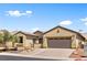 Attractive single-story home with a paved driveway, two-car garage, desert landscaping, and solar panels at 4212 Helens Pouroff Ave, North Las Vegas, NV 89085