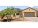 Inviting single-story home with a landscaped front yard, stone accents, a paved driveway, and a two-car garage at 4212 Helens Pouroff Ave, North Las Vegas, NV 89085