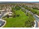 Lush green space in a residential community, framed by mature trees and well-maintained landscaping at 4212 Helens Pouroff Ave, North Las Vegas, NV 89085