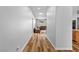 Hallway leading to an open-concept living room and kitchen with hardwood floors at 4212 Helens Pouroff Ave, North Las Vegas, NV 89085