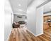 Hallway leading to an open-concept living room and kitchen with hardwood floors at 4212 Helens Pouroff Ave, North Las Vegas, NV 89085