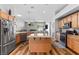 Spacious kitchen featuring stainless steel appliances, granite countertops, center island, and open floor plan at 4212 Helens Pouroff Ave, North Las Vegas, NV 89085