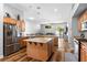 Spacious kitchen featuring stainless steel appliances, granite countertops, center island, and open floor plan at 4212 Helens Pouroff Ave, North Las Vegas, NV 89085