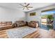 Bright living room showcasing hardwood floors, ceiling fan, and sliding glass door at 4212 Helens Pouroff Ave, North Las Vegas, NV 89085