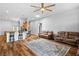 Open-concept living room with hardwood floors connecting to the kitchen at 4212 Helens Pouroff Ave, North Las Vegas, NV 89085