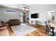 Open-concept living room featuring hardwood floors, ceiling fan, and sliding glass door at 4212 Helens Pouroff Ave, North Las Vegas, NV 89085