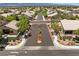 Street view of a neighborhood entrance showing manicured landscaping and controlled access for a private community at 4212 Helens Pouroff Ave, North Las Vegas, NV 89085
