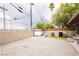 Backyard featuring brick landscaping, partial grass coverage, and tan walls at 4232 Park Ct, Las Vegas, NV 89110