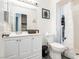 Bathroom vanity featuring white cabinetry, a mirror, a shower-tub combo, and modern fixtures at 4232 Park Ct, Las Vegas, NV 89110