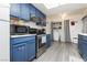 Cozy kitchen featuring blue cabinetry, modern appliances, and a skylight for natural lighting at 4232 Park Ct, Las Vegas, NV 89110