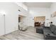 Bright living room with a large recliner, modern sofa, and open access to dining area at 4232 Park Ct, Las Vegas, NV 89110