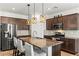 Modern kitchen with stainless steel appliances, granite countertops, and pendant lighting over the island at 438 Shimmering Sands Ave, North Las Vegas, NV 89031