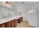 Bright bathroom features double sinks, large mirrors and shower with glass doors at 4641 Therapeutic St, North Las Vegas, NV 89031