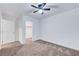 Neutral carpeted bedroom with lighted ceiling fan, closet, and walk in closet access at 4641 Therapeutic St, North Las Vegas, NV 89031
