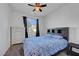 Comfortable bedroom with a ceiling fan, dresser, carpet flooring, and natural light at 4641 Therapeutic St, North Las Vegas, NV 89031