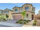 Home exterior showcasing a two-car garage, desert landscaping, and a brick driveway at 4641 Therapeutic St, North Las Vegas, NV 89031