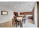 Spacious kitchen and dining area with a table set for six at 4641 Therapeutic St, North Las Vegas, NV 89031