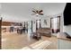 Open-concept living space featuring tile floors, a ceiling fan, and lots of natural light at 4641 Therapeutic St, North Las Vegas, NV 89031
