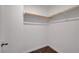 Bright walk-in closet with neutral carpet and ample shelving for storage at 4641 Therapeutic St, North Las Vegas, NV 89031