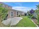 Cozy backyard with a concrete patio, bordered by green grass and mature landscaping at 4708 Cohiba Way, North Las Vegas, NV 89031