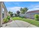 A tranquil backyard offers a simple concrete patio surrounded by a green lawn and shrubbery at 4708 Cohiba Way, North Las Vegas, NV 89031
