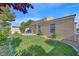 Inviting backyard featuring a well-maintained lawn and partial landscaping surrounding the home's exterior at 4708 Cohiba Way, North Las Vegas, NV 89031
