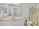 Bright bathroom featuring a large mirror, updated fixtures, and a glass shower at 4708 Cohiba Way, North Las Vegas, NV 89031