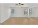 Bright bedroom with wood floors, ceiling fan, closet with mirrored doors, and two windows at 4708 Cohiba Way, North Las Vegas, NV 89031