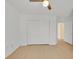 Bedroom with light floors, ceiling fan, double closet, and access to bathroom at 4708 Cohiba Way, North Las Vegas, NV 89031