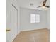 Bedroom features light floors, a ceiling fan, and a closet with sliding doors at 4708 Cohiba Way, North Las Vegas, NV 89031