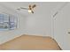 Clean bedroom with light wood floors, ceiling fan, and large window with blinds at 4708 Cohiba Way, North Las Vegas, NV 89031
