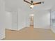 Bright bedroom with wood-look floors, a ceiling fan, and a view into the attached bathroom at 4708 Cohiba Way, North Las Vegas, NV 89031
