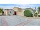 Charming single-story home featuring a two-car garage, red front door, and well-maintained landscaping at 4708 Cohiba Way, North Las Vegas, NV 89031
