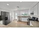 Updated kitchen featuring stainless steel appliances, white cabinets, and a window above the sink at 4708 Cohiba Way, North Las Vegas, NV 89031