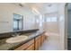 Bathroom featuring a granite countertop, double sinks, and tiled shower at 5282 Monterey Park Cir, Las Vegas, NV 89146